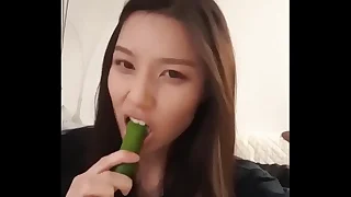 Asian Girl Sucks Cucumber